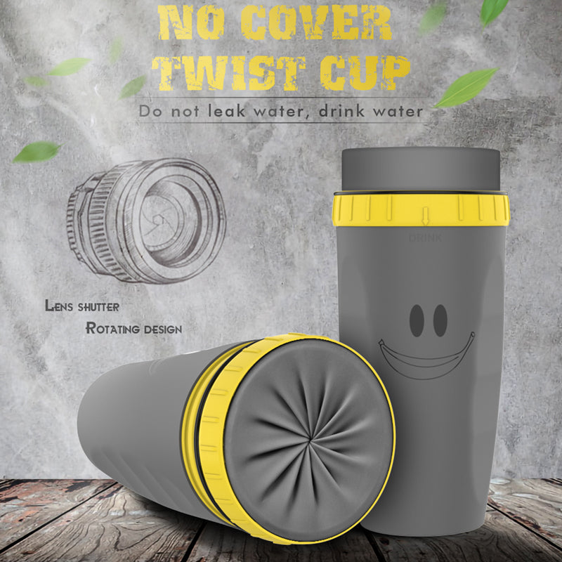 Gray and yellow twist cup with smiley face design on a wooden surface and gray background.