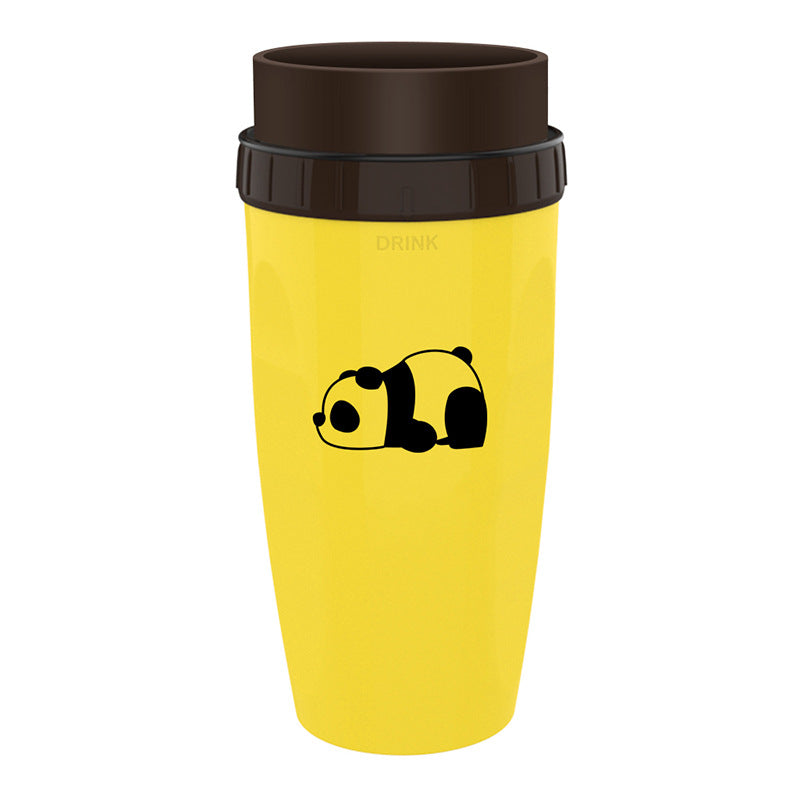 Yellow travel mug with a black panda design and black lid on a white background