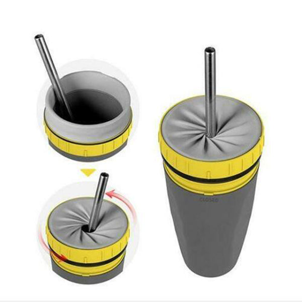 Gray tumbler with yellow bands and metal straw on a white background