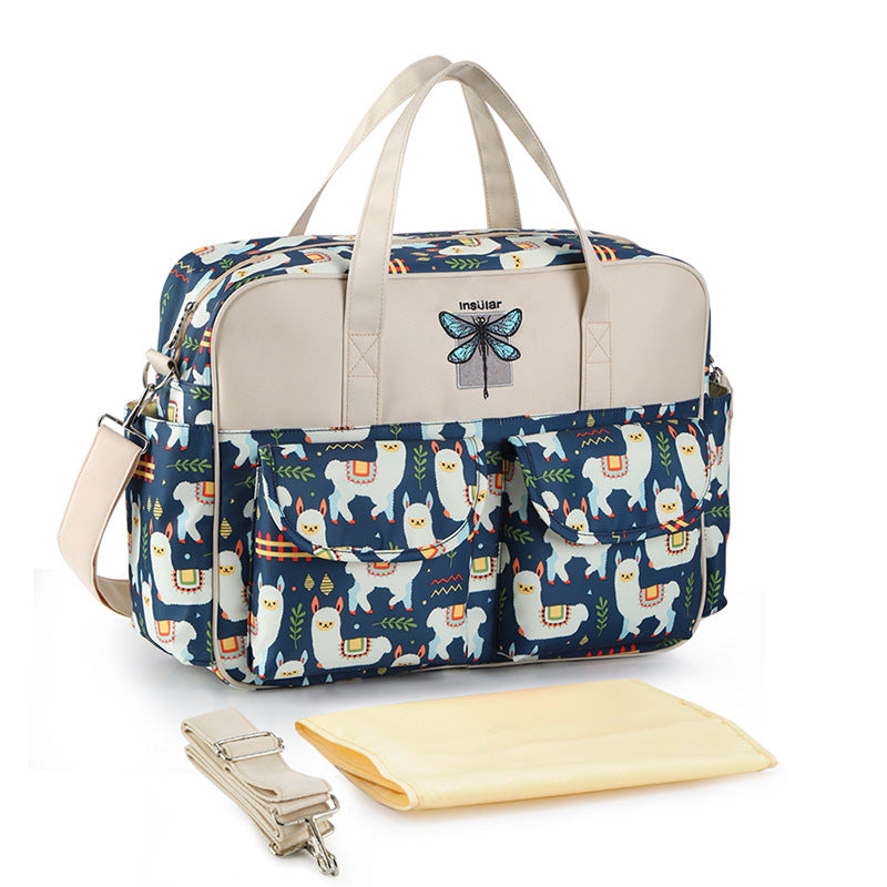 Diaper bag with llama pattern and accessories on a white background