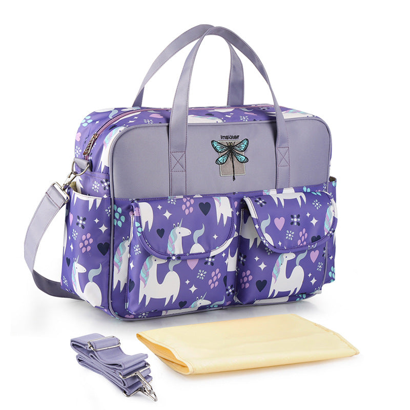 Purple diaper bag with unicorn pattern on a white background
