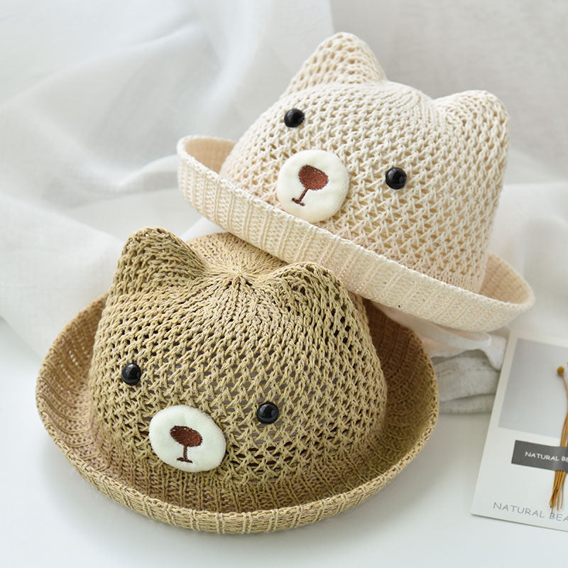 Two knitted cat hats, one beige and one brown, on a white background.