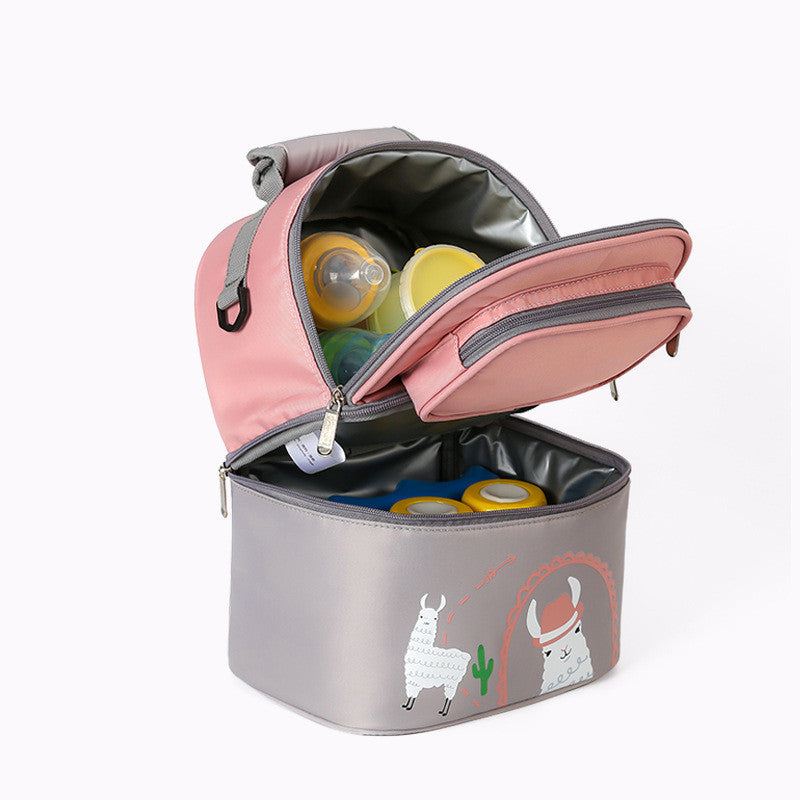 Pink and gray insulated travel bag open with baby items inside on a white background. 
