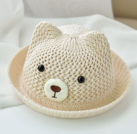 Knitted hat with a bear face design on a white background