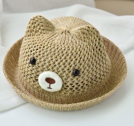Knitted hat with bear face design on a white surface