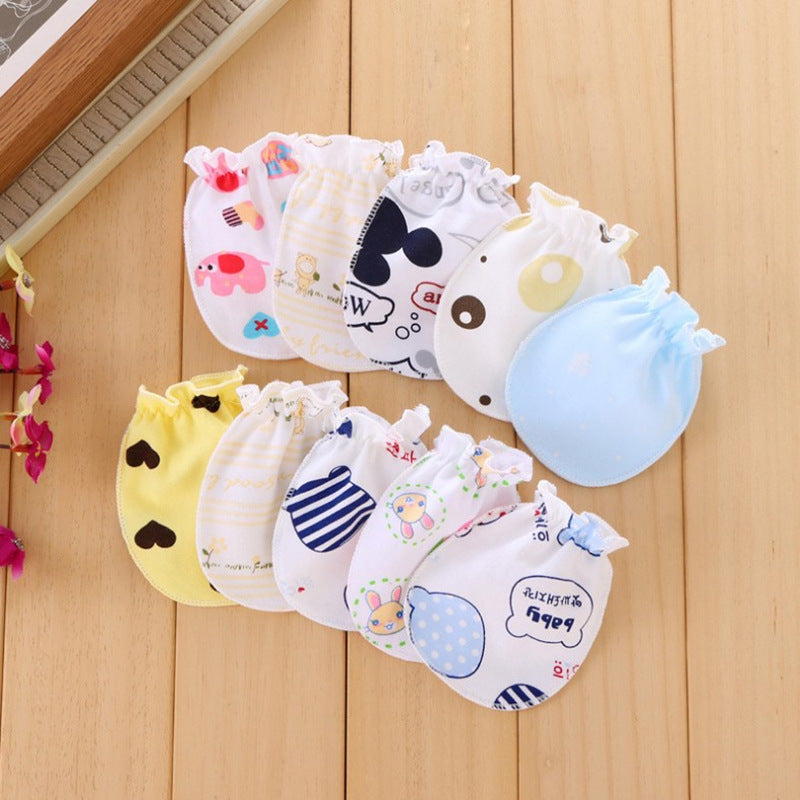 Set of colorful baby bibs with various designs on a wooden surface