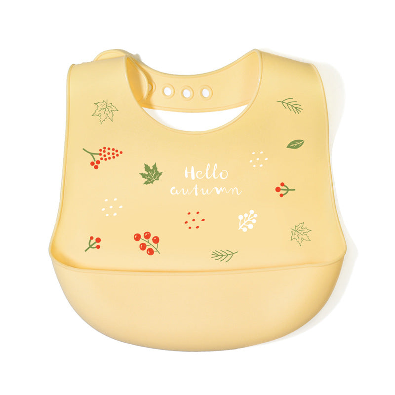Yellow bib with autumn-themed design on a white background