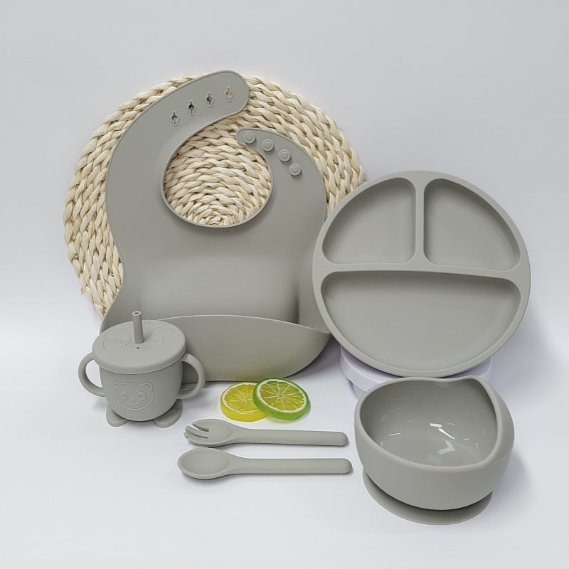 Children's dining set with plate, bowl, cup, and utensils on a white background
